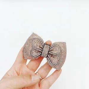 Rhinestone bow spring hair clip detail view, elegant champagne crystal hairpin for women.