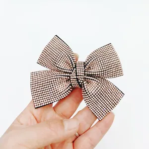Champagne rhinestone bow hair clip detail shot, elegant crystal barrette for women.