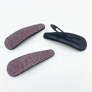 Close-up details of sparkling pink rhinestone snap hair clips showing front and back metal structures.