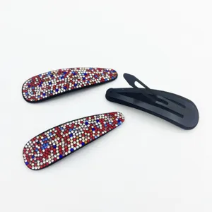 Rhinestone hair clip detail showing sparkling multi-color crystals and black snap back.
