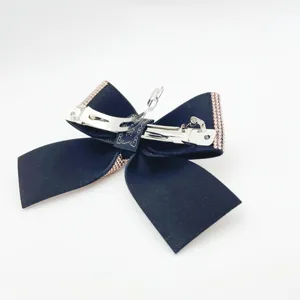 Detail view of the black bow hair clip with sparkling rhinestone edge and sturdy metal spring.