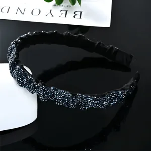 Detailed view of the black rhinestone baroque headband with sparkling crystals and wide pleated design.
