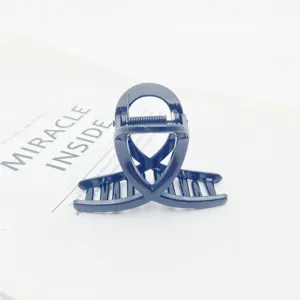 Detailed view of a small dark hair claw clip with geometric design, perfect for fine hair.