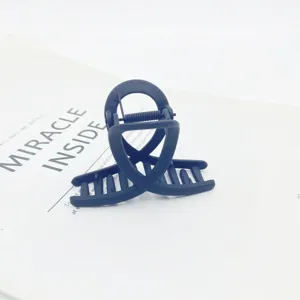 Black matte small hair claw clip, minimalist style hair accessory for daily styling.