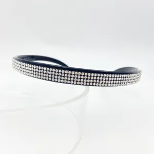 Detailed view of black rhinestone headband with sparkling crystal rows for women elegance.