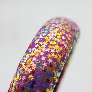 Close-up detail view of a wide fashion headband covered in colorful holographic star sequins.