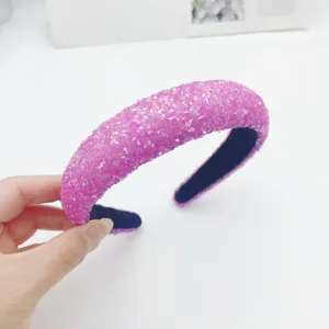 Pink glitter sequin headband detail shot, stylish wide hair hoop accessory for women.