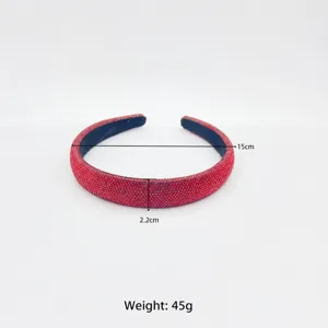 Detailed view of the red rhinestone padded headband showing width and diameter clearly.
