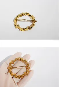 Close-up detail of vintage gold leaf wreath hair clip, elegant metal floral design for styling.