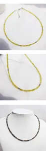 Detailed close-up view of handmade faceted natural stone beaded necklace, delicate clavicle chain.