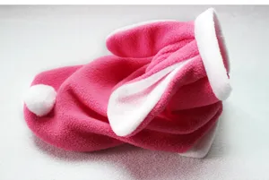 Close-up detail of the cute pink plush pet rabbit costume with white ears and tail fluffy.