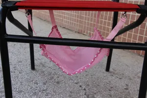 Detailed view of breathable pink polka dot pet hanging hammock with metal hooks for cats and dogs.