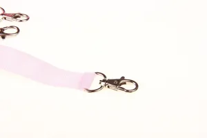 Pink strap with metal swivel lobster clasp hook for pet hanging accessories detail view.