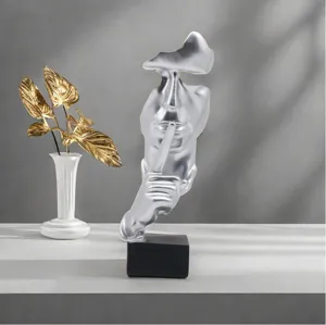 Abstract silver silence is golden figure sculpture detail shot, elegant resin home decor ornament.
