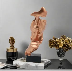 Abstract resin silence face sculpture detail, modern bronze decorative ornament for home office desk.