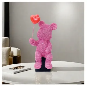 Detail view of pink rhinestone bear resin figurine holding red heart balloon for home decor.