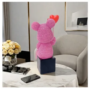 Detail view of pink rhinestone bear resin sculpture ornament in luxury living room.
