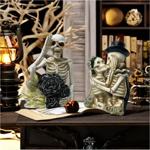 Halloween resin skeleton couple ornament detail shot, spooky holiday home desk party decor.