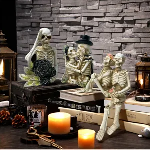 Detailed view of Halloween skeleton resin figurines with atmospheric candle and book props.