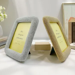 Decorative pearl beaded photo frames in silver and gold, elegant resin desktop picture displays.