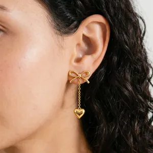 Gold stainless steel bow and heart pendant drop earrings for women, chic fashion jewelry.
