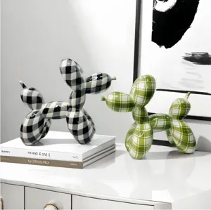 Detail shot of modern plaid resin balloon dog sculpture, stylish desktop home decor ornament.