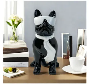 Detailed shot of resin French bulldog ornament with sunglasses and scarf for desktop decor.