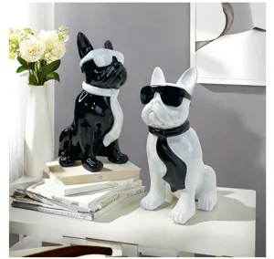 Detailed shot of resin French bulldog decor figurine with glasses and ribbon scarf, chic.