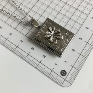 Vintage silver book locket necklace with four leaf clover pendant for daily wear.