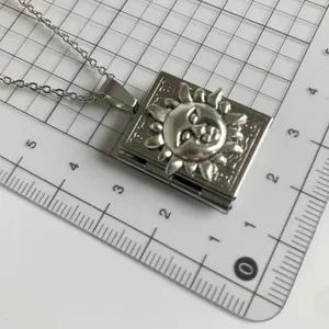 Vintage silver sun book locket necklace, unique pendant jewelry with chain accessory.