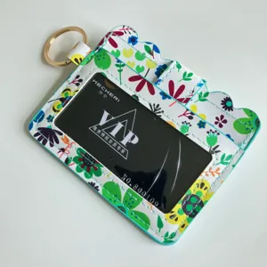 Floral print card holder with keychain, clear ID window, compact floral wallet for women detail.