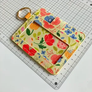 Floral print PU leather card holder with ID window, keyring and slots for daily use.