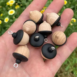 Solid wood acorn charm pendant detail showing natural texture and black cap for DIY jewelry accessories.