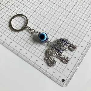 Vintage evil eye elephant metal keychain with blue rhinestones for stylish daily use.
