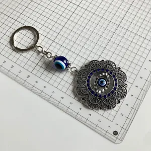 Vintage turkish evil eye keychain featuring blue rhinestones and metal pendant detail.