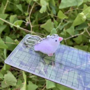 Flocked 3D cartoon animal magpie keychain detail shot showing actual size scale.