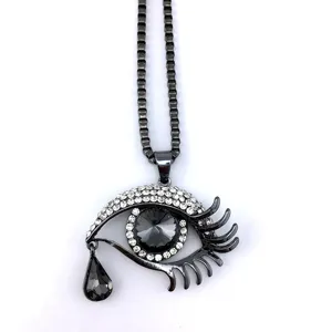 Detailed view of the crying eye crystal long sweater necklace, alloy metal and rhinestones.
