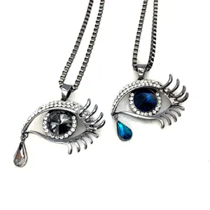 Detailed view of crystal eye pendant necklace, silver alloy box chain, unique design.