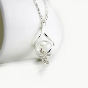 Exquisite dandelion glass ball necklace detail featuring silver twisted cage pendant.