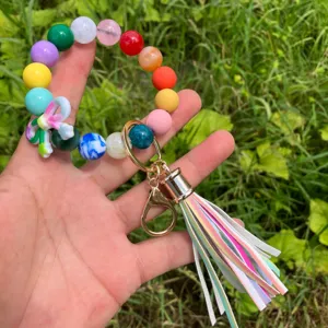 Colorful beaded bracelet keychain with PU leather tassel and cute bow, stylish accessory.