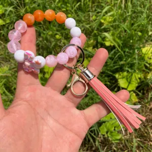 Colorful beaded keychain with butterfly charm and PU leather tassel for women wrist strap.