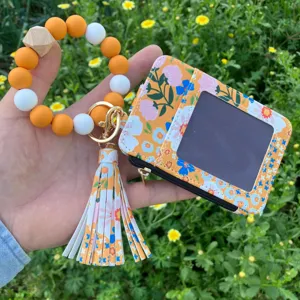 Porta carte floreale con braccialetto di perline in silicone e bellissimo nappa dettaglio.