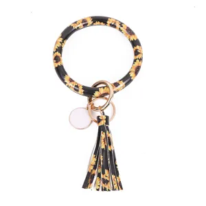 Zonnebloem patroon PU leer cirkel sleutelhanger met stijlvolle kwast hanger detail.