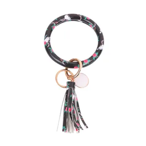 PU lederen ronde armband sleutelhanger met stijlvolle tassel hanger en bloemenprint.