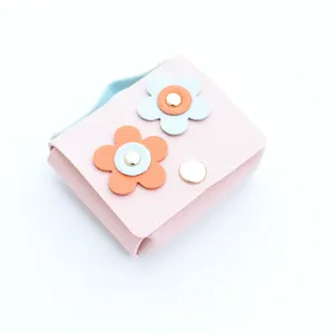 Close-up detail of the cute pink leather flower coin purse, perfect earphone case pendant.