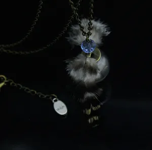 Collana maglione con palla di vetro di piuma vintage con cristallo blu e catena di bronzo.