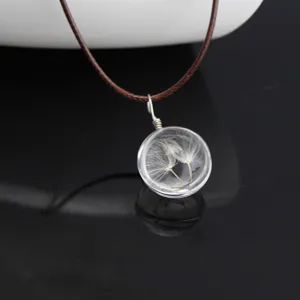 Handcrafted glass ball necklace featuring natural real dandelion seeds inside with brown cord.