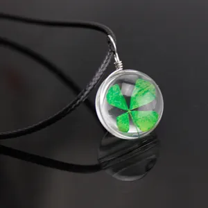 Four leaf clover glass ball pendant necklace, real plant specimen in clear glass sphere.