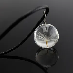 Dandelion seed glass globe pendant necklace with black cord detail close-up shot.