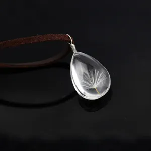 Dandelion glass teardrop pendant necklace with brown leather cord, clear botanical jewelry.